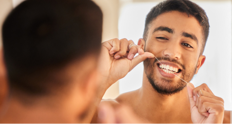 чоловіки використовують зубну нитку